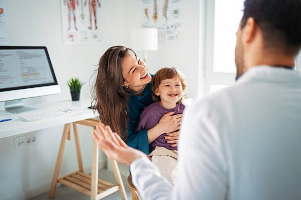 istock Child and Mom Visiting Pediatrician for Routine Exam 2212114252