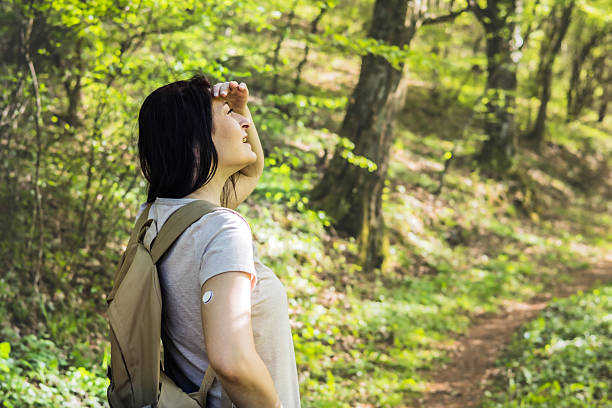 istock Connecting with nature. Active woman backpacker with diabetes exploring forest. She is wearing small sensor on the back of upper arm for controlling blood sugar. Hiking with chronic illness. 2212115084