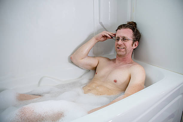 istock Relaxed Man Enjoying Bubble Bath at Home 2212115139