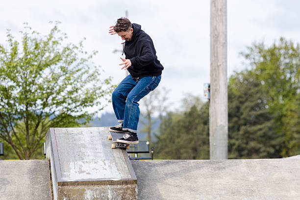 istock Skilled Skateboarder Doing Tricks at Skatepark 2212117206
