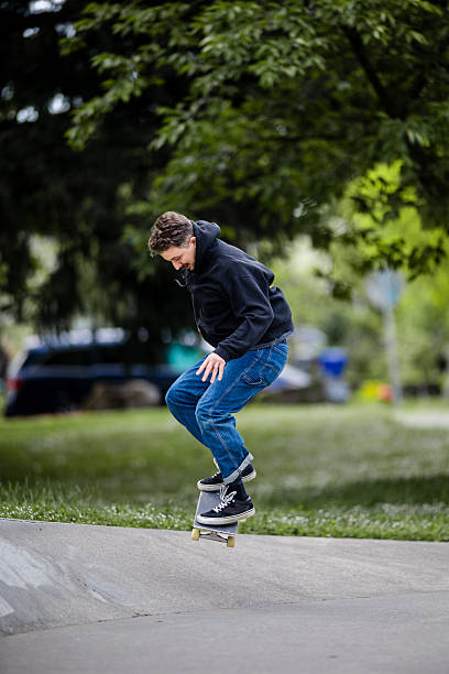 istock Skilled Skateboarder Doing Tricks at Skatepark 2212117241