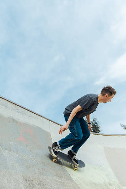 istock Skilled Skateboarder Doing Tricks at Skatepark 2212117302