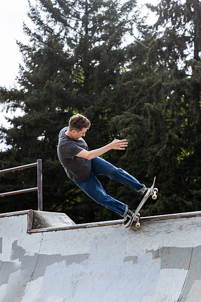 istock Skilled Skateboarder Doing Tricks at Skatepark 2212117312
