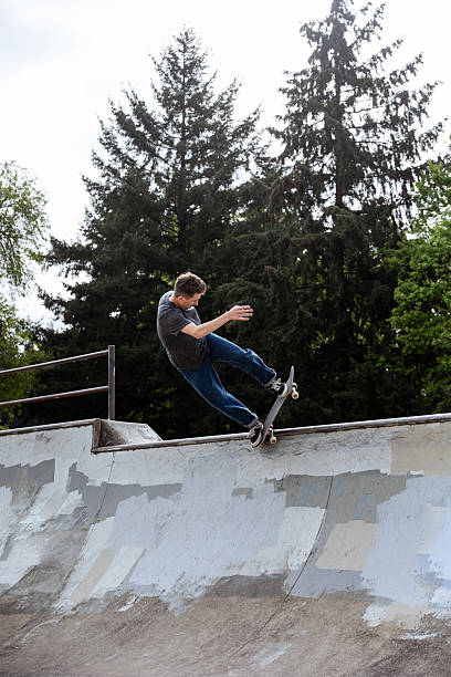 istock Skilled Skateboarder Doing Tricks at Skatepark 2212117328