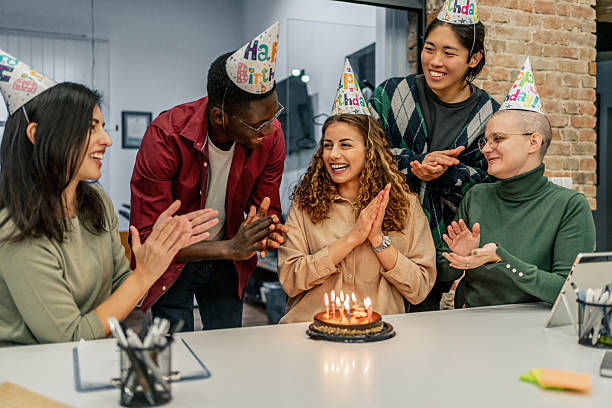 istock Colleagues clapping and celebrating birthday in the office 2212119957