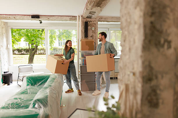 istock Young Couple Carrying Boxes into New Apartment 2212120262