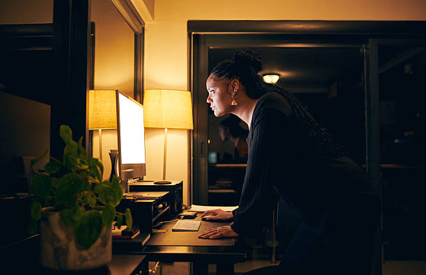 istock Focused Woman Working Late at Night 2212125557