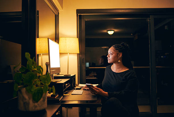 istock Focused Woman Working Late at Home Office 2212125563