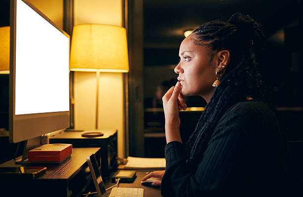istock Focused Woman Working Late at Desk 2212125571