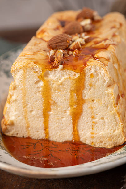 istock A detailed close-up captures a traditional caramelized egg white pudding known as molotof or molotov, generously drizzled with rich caramel syrup and garnished with whole and chopped almonds 2212126125