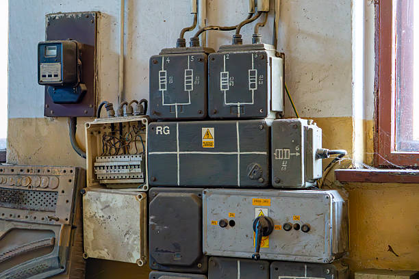istock Old electrical installation with meters and distribution boxes mounted on a wall in an abandoned building. Obsolete devices and technical markings are visible 2212128274