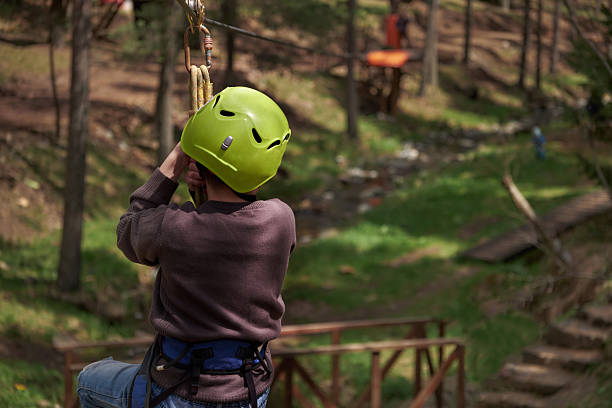 istock Rear view of unrecognizable boy on the zipline 2212129307