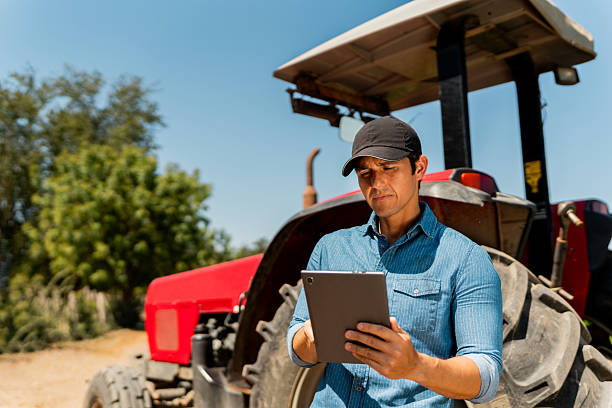 istock Mid adult farmer man using digital tablet at agricultural field 2212132026