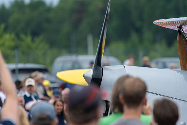 Kharkiv, Ukraine - August 29, 2021: Light red aircraft plane Su-31 on landing runway grass airfield at KharkivAviaFest with scenic cloudy sky