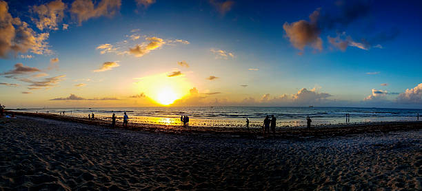 Distant cargo ship on the horizon under cloudy skies at Miami Beach in United States, Florida, Miami