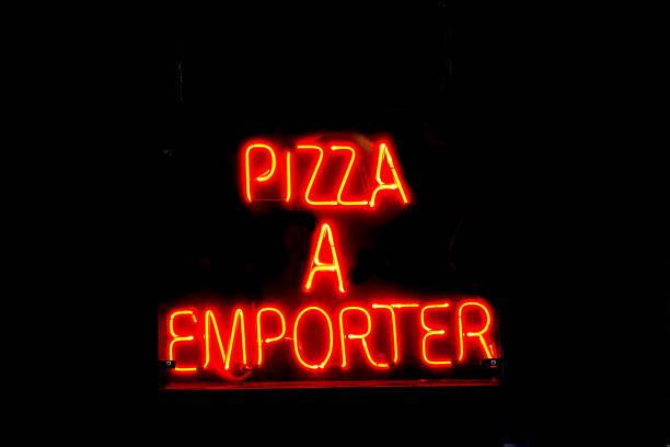istock France: Neon Sign in Black Window: PIZZA A EMPORTER (Take-out) 2212139000