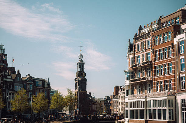 The munttoren, or mint tower, stands tall along the canals of amsterdam on a sunny day