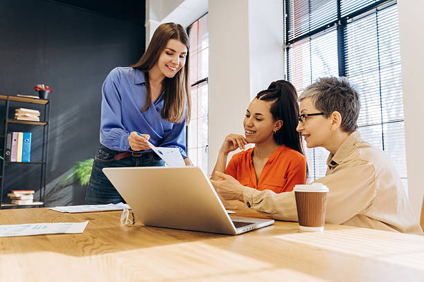 istock Businesswomen working together on a project using laptop and documents in office 2212145377