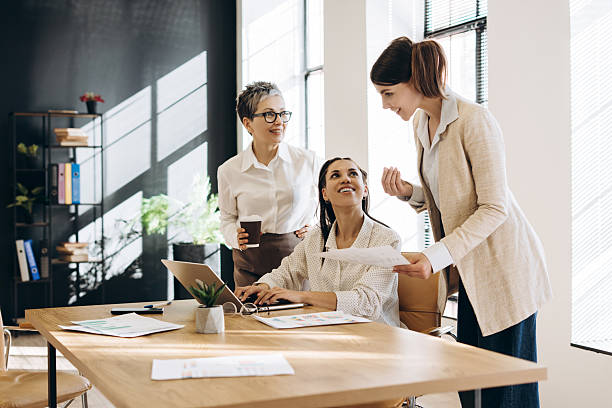 istock Businesswomen working together on project in modern office 2212145608