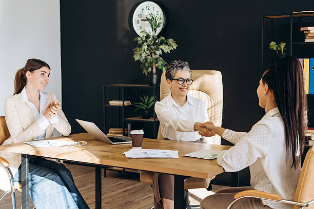istock Businesswomen shaking hands after successful job interview 2212145648