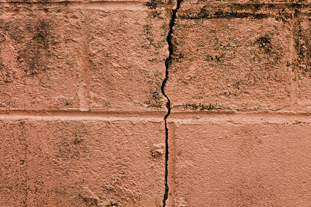 istock Cracked wall after an earthquake. Mouldy and cracked whitewashed wall 2212145870