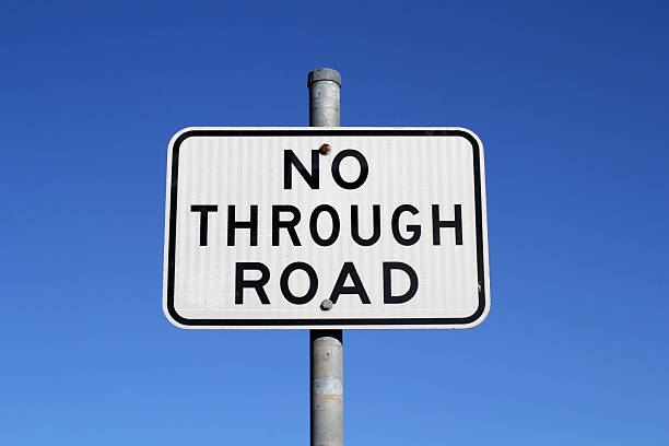 istock No Through Road sign against a clear blue sky background 2212159408