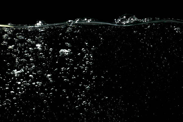 istock Air Bubbles Float Up in Water on Black. Splashing Water Wave, Oxygen Relaxation. Pure Drinking Water. Water Bubbles Textured on Black Background. 2212165873