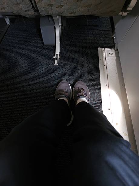 istock A passenger relaxes with ample legroom in an exit row seat on a commercial airplane. 2212170175