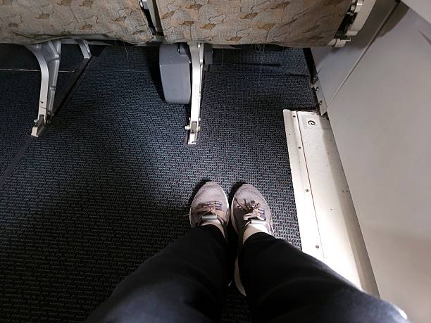 istock A passenger relaxes with ample legroom in an exit row seat on a commercial airplane. 2212170178