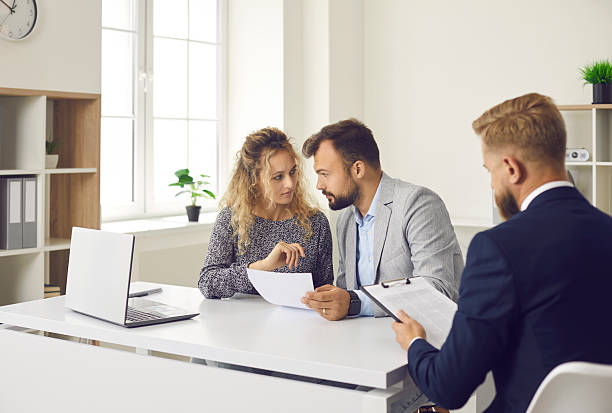 istock Couple clients read document have meeting with real estate agent in office 2212171442
