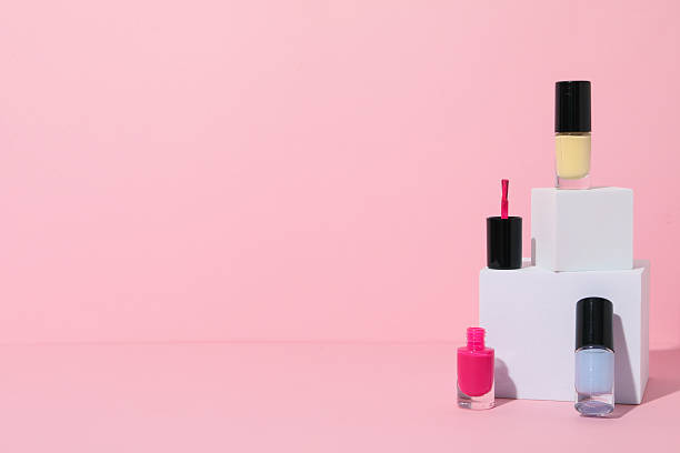 istock Multicolored nail polishes with white wooden cubes 2212174613