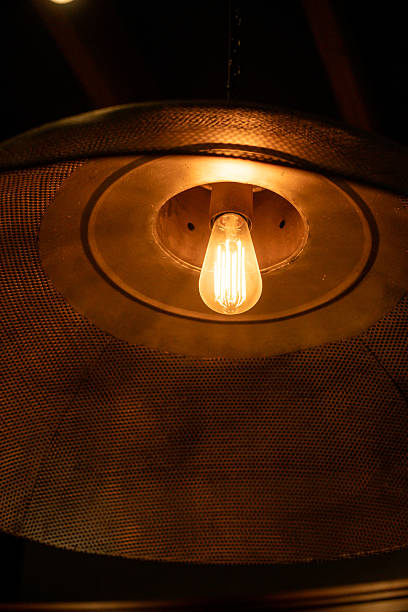 istock Hanging Edison light bulb, also known as filament light bulb. with metal shade 2212178200