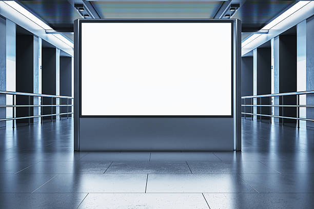 istock Blank billboard mockup in modern indoor corridor with clean metallic design and reflective floor surface for advertising display concept. 3D Rendering 2212182838