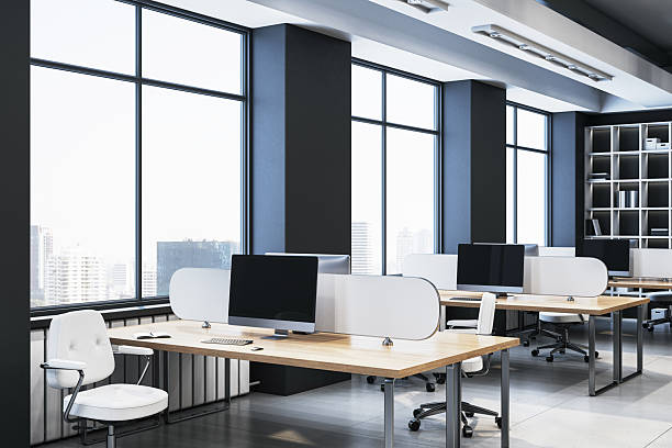 istock Modern empty office interior with wooden desks, white chairs, and large glass windows showcasing a bright city view in a corporate workspace. 3D Rendering 2212182905