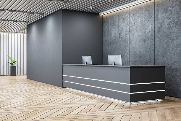 istock Modern dark office reception desk with computers in luxury loft interior with wooden parquet floor and concrete wall, company logo mockup concept. 3D Rendering 2212182917