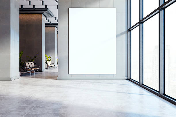 istock Vertical blank poster mockup on wall in modern office hallway with large windows and city view in bright daylight interior. 3D Rendering 2212182942