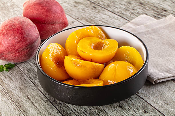 istock Sweet ripe yellow canned peaches 2212183475