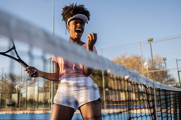 istock Tennis player celebrating winning point on court 2212183846