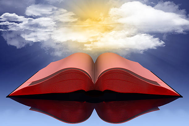 istock Open red book with sky background towards the sun. 2212185917