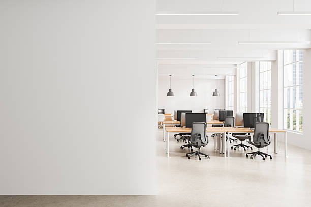 istock Minimalist office interior with blank wall for poster mockup and bright open workspace with modern furniture and large windows for natural light. 3D Rendering 2212186265