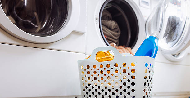 istock Laundry in a basket with detergent at laundromat 2212186504
