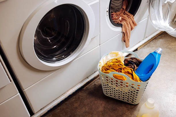 istock Basket with dirty clothes at laundromat 2212186516