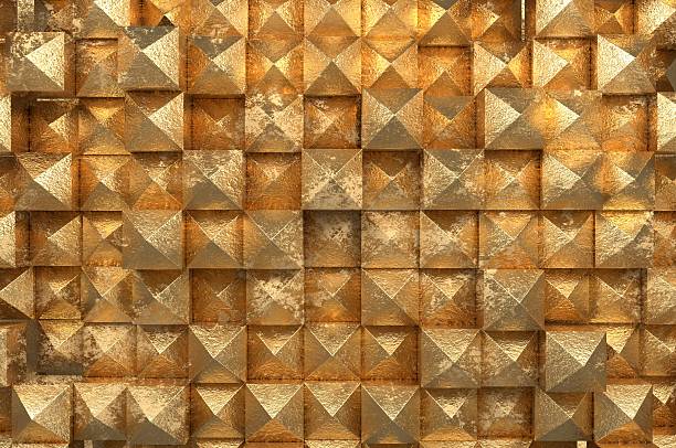 Gleaming metallic pyramids form a seamless geometric pattern, radiating warmth through rich gold textures and subtle aging effects. The repeating three-dimensional surface combines luxury and ruggedness, creating a visually striking, tactile backdrop. Ideal for high-end design, opulent branding, and architectural inspiration.