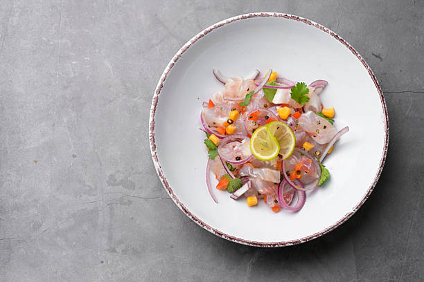 Bowl of fresh ceviche decorated with lime, corn with copy space for text