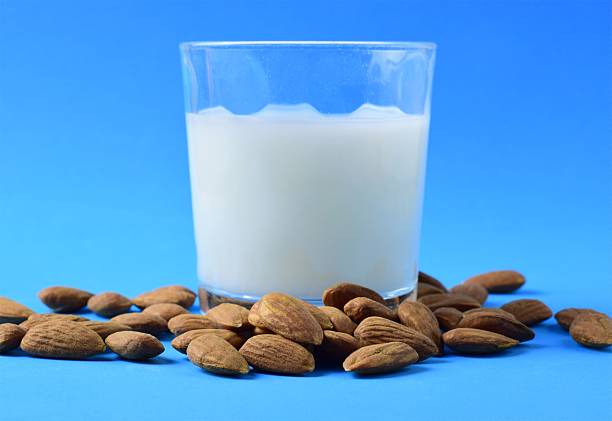 istock Almond Milk and Almonds on Blue Background 2212190401