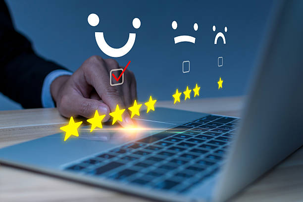istock Satisfaction. business people hand touching on laptop computer with virtual graphic five star button to review good rating, digital marketing, good experience, product rating review concept 2212190507