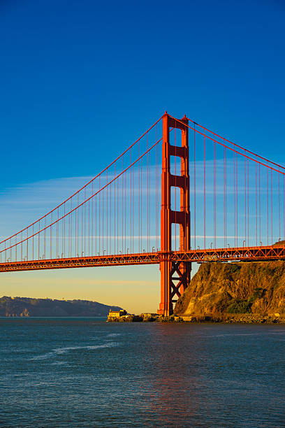 The iconic Golden Gate Bridge in San Francisco, California, spanning across the bay with its striking red towers. This world-famous suspension bridge is a must-see landmark, offering breathtaking views of the city, water, and surrounding hills.