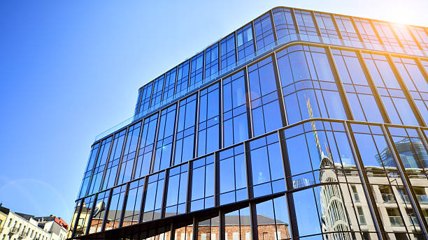istock Modern office building with glass facade on a clear sky background. 2212193059
