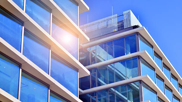 istock Downtown corporate business district architecture. Glass reflective office buildings against blue sky and sun light. 2212193164