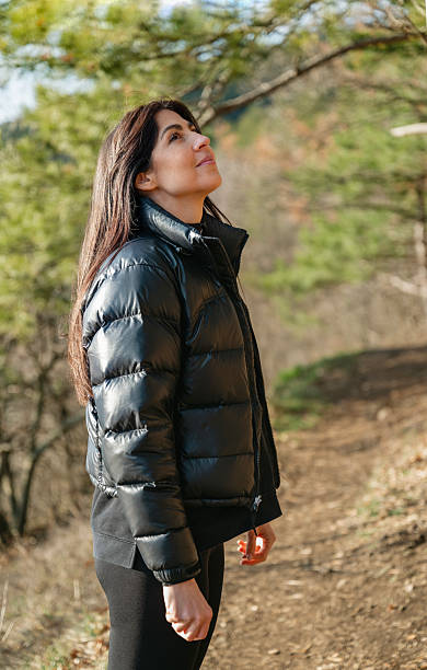 istock Relaxed woman breathing fresh air in a pine forest 2212195355
